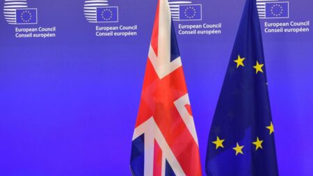A British Union Jack flag and a European Union flags are seen ahead of a meeting between British Prime Minister