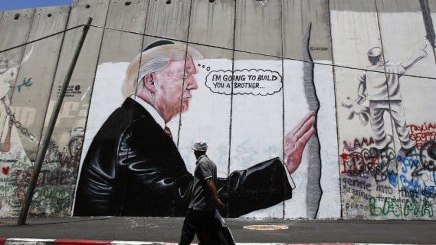 Graffiti on West Bank barrier shows Trump wearing a skullcap, saying "I'm going to build you a brother
