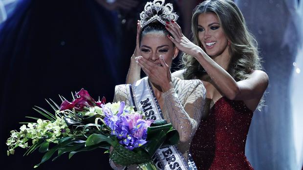 Former Miss Universe Iris Mittenaere, right, crowns new Miss Universe Demi-Leigh Nel-Peters at the Miss Universe pageant Sunday