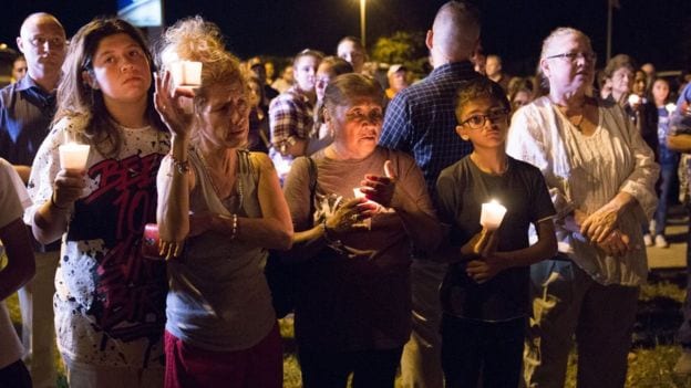 A community of mourners hold vigils at church where 26 people were killed