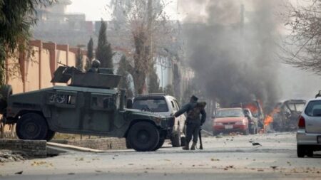 A suicide attacker detonates a bomb at the gates of the charity save the children compound in Jalalabad, in Afghanistan