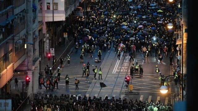 Protesters form a barrier in a standoff against the police, as they confront with police in Hong Kong 