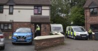 A woman has been arrested after the body of a 10 year old boy was found in a caravan