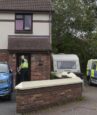 A woman has been arrested after the body of a 10 year old boy was found in a caravan