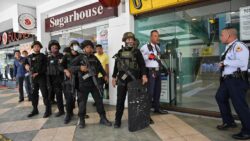 Filipino Police surround a mall in Manila after a gunman takes 30 hostages