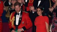 Prince Harry appeared in a Royal Marines officer's mess jacket while Meghan wore a designer dress.