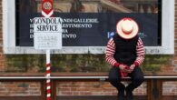 A gondolier checks his mobile phone while waiting for tourists in Venice - As italians try to kickstart the economy