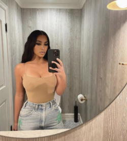 Kim Kardashian goes braless as she puts her famous curves on display in a nude tank top