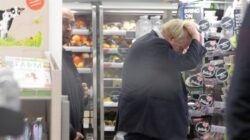 Boris Johnson scratches his head while shopping in M&S without a mask
