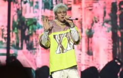 Machine Gun Kelly pelted with bottles and narrowly avoids being hit by tree branch during festival