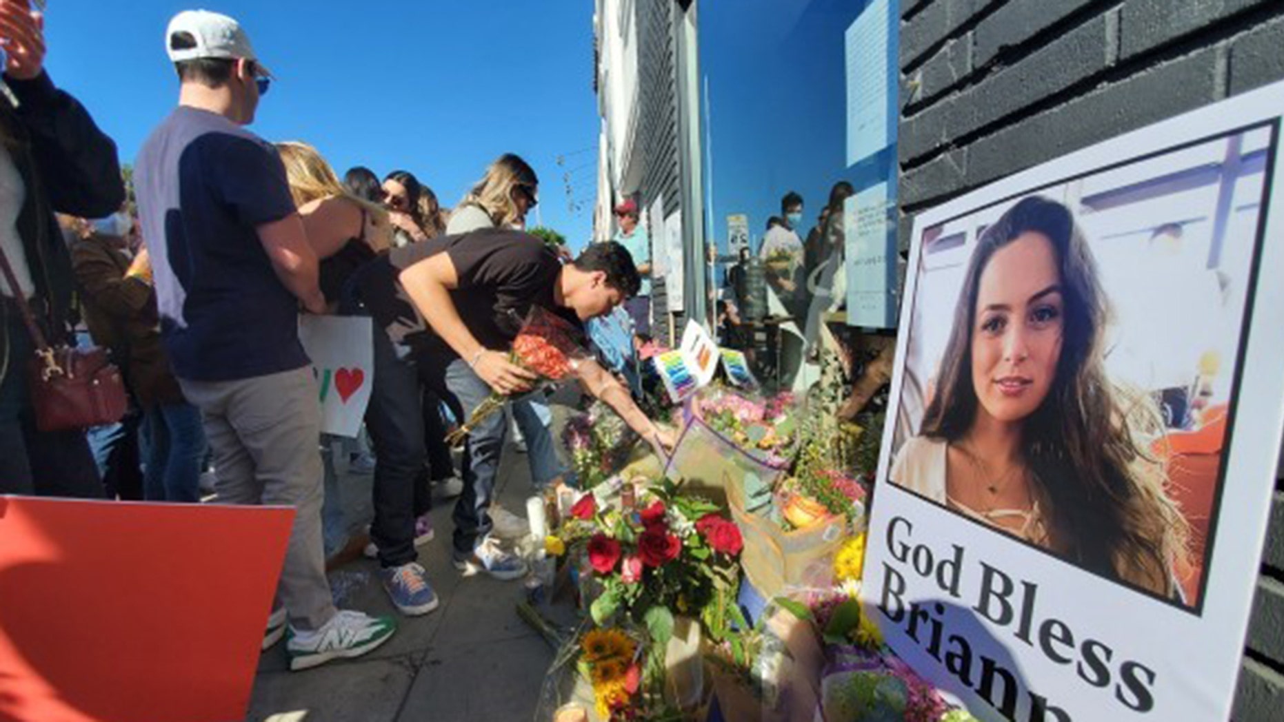 Flowers flood the sidewalk in front of the Croft House, where Brianna Kupfer was killed on Jan. 13