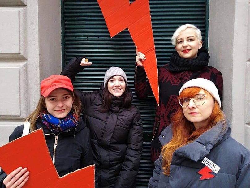 Fighting against abortion ban protests - activists hold up the red lightning bolt that has become a symbol of Poland's pro-choice movement