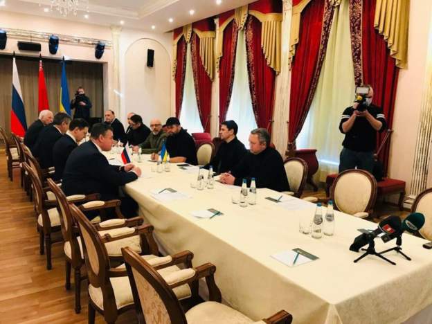 Ukraine and Russian officials sit on opposite sides of a table