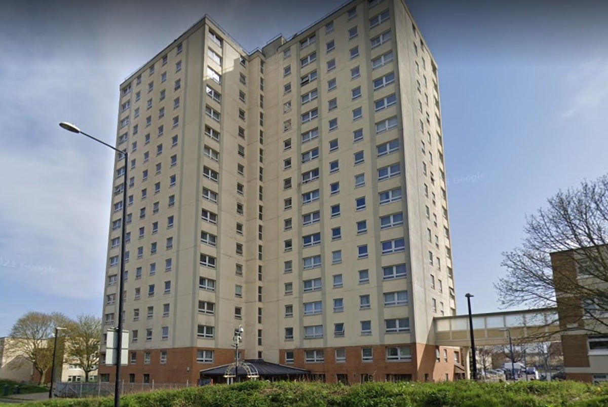 Woman falls to her death at block of flats with man arrested on suspicion of murder