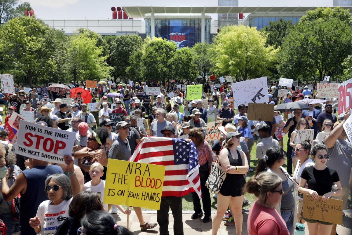 Protesters gather outside NRA convention centre in Houston, Texas