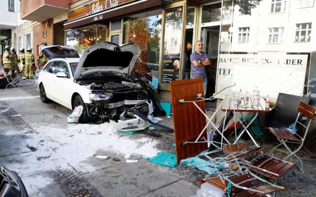 One dead and dozens injured after car crashes into people outside Berlin cafe