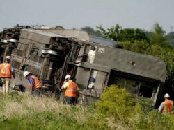 Three dead after train crashes into lorry and flips over