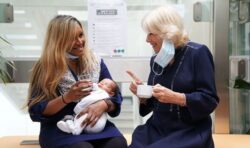 Camilla coos over baby during first solo trip as Queen Consort at London hospital