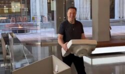 Elon Musk makes a splash carrying a sink at Twitter Headquarters