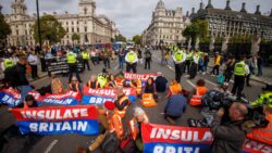 Eco yobs cause chaos outside Parliament after glueing themselves to road