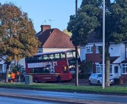 Bus driver dies at the wheel and crashes double-decker into a BMW and a house