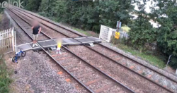 CCTV shows toddler left walking on train track while father talks on phone