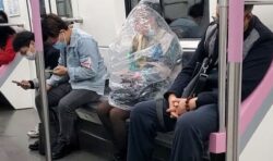 Wuhan subway passenger covers entire body in plastic bag to eat banana