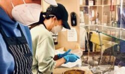 Meghan Markle looks unrecognisable in new picture as she dons rubber gloves and cap