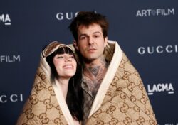 Billie Eilish and boyfriend Jesse Rutherford cosy up in more ways than one as they make red carpet debut wrapped in blanket