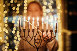 What is the meaning of Hanukkah and how many candles do you light?