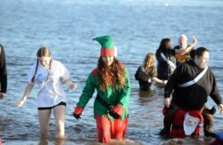 Little Mix’s Jade Thirlwall goes for Boxing Day swim in icy waters dressed as an elf