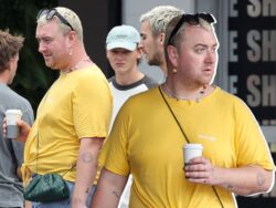 Sam Smith showcases tattoos in denim mini-shorts and yellow T-shirt combo in Sydney before ringing in 2023 in Australia