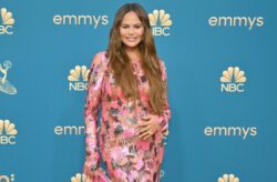 Glowing Chrissy Teigen gets some sun on her bare bump on family holiday before welcoming new baby