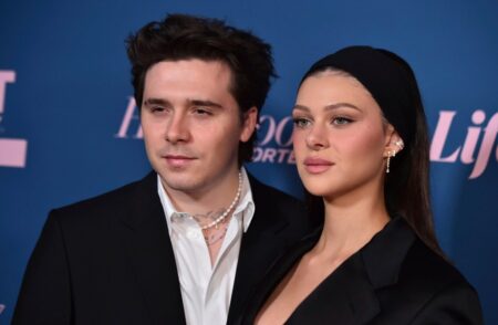 Brooklyn Beckham and Nicola Peltz enjoy impromptu photoshoot as they share smooch in the rain