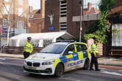 Man arrested on suspicion of murder after three shot in church drive-by attack