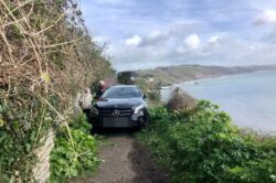 Mercedes driver takes wrong turn down coastal path and abandons car