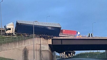 M1 and A14 closures after crash that left lorry hanging off bridge