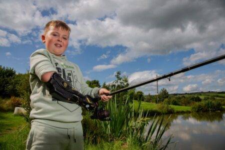 Boy, 7, born without arm can now fish with his dad using bionic limb