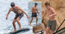 Chris Martin, 46, defies gravity on very cool electric surfboard during Ibiza holiday with son Moses, 17