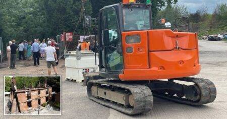 Protesters block the road as diggers arrive at the Crooked House rubble