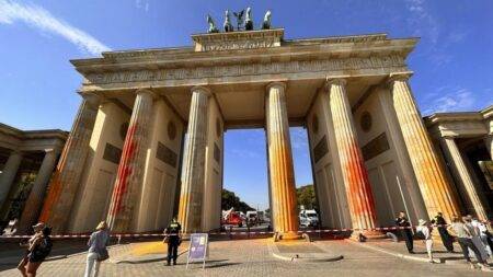 Activists spray paint on Berlin’s Brandenburg Gate in call for climate action