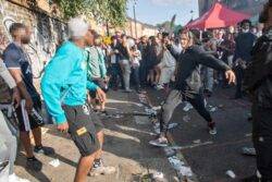 Knife thugs armed with huge machetes brawl in street in front of crowds of revellers at Notting Hill carnival