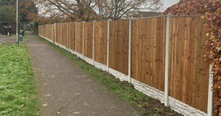 Unknown person buys green space in village and builds fence around it