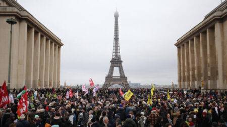 Tens of thousands of protesters across France call on Macron not to sign immigration law