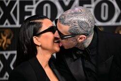 Kourtney Kardashian and Travis Barker literally making love with their faces at Emmys