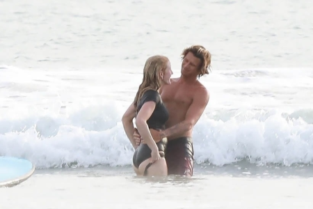Ellie Goulding kisses & cuddles young surfing instructor while husband Caspar Jopling remains home in marriage riddle