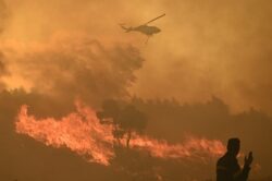 Greek residents flee as wildfire rages uncontrolled near Athens