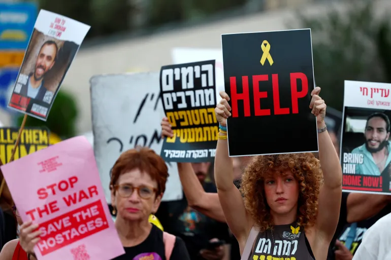 The families of captives held in Gaza hold a protest in Tel Aviv to mark one year since the October 7