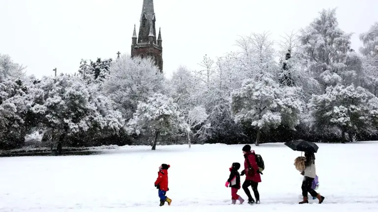 UK weather: snow and ice warning as commuters face widespread disruption