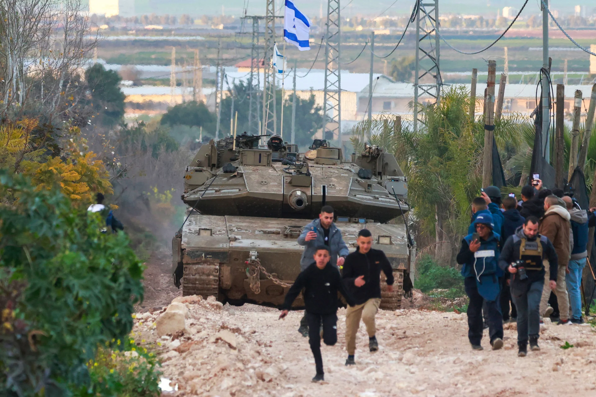 West Bank
Palestinians disperse as Israeli tanks enter the Jenin camp for refugees in the occupied West Bank.